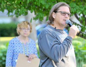 -Daily Freeman Journal photo by Hans Madsen Webster City Artist Tim Adams talks about his sculpture “Resonance” during the Arts R Alive event Thursday in Twin Parks West. Arts R Alive chair Janet Adams, listens at left.